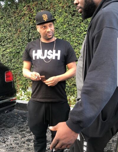 A man in black shirt holding a cell phone.