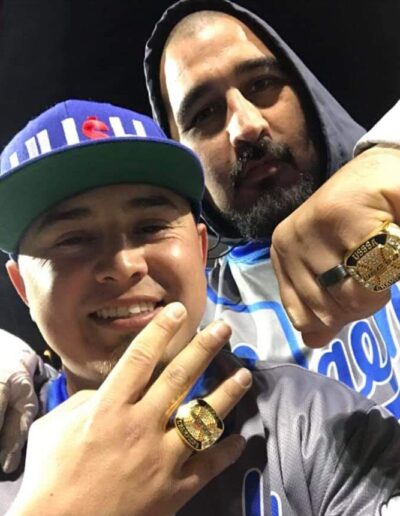 Two men pose for a picture with their rings.